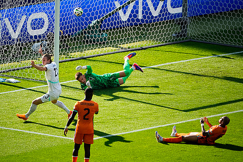 Donyell Malen reacts after scoring an own goal